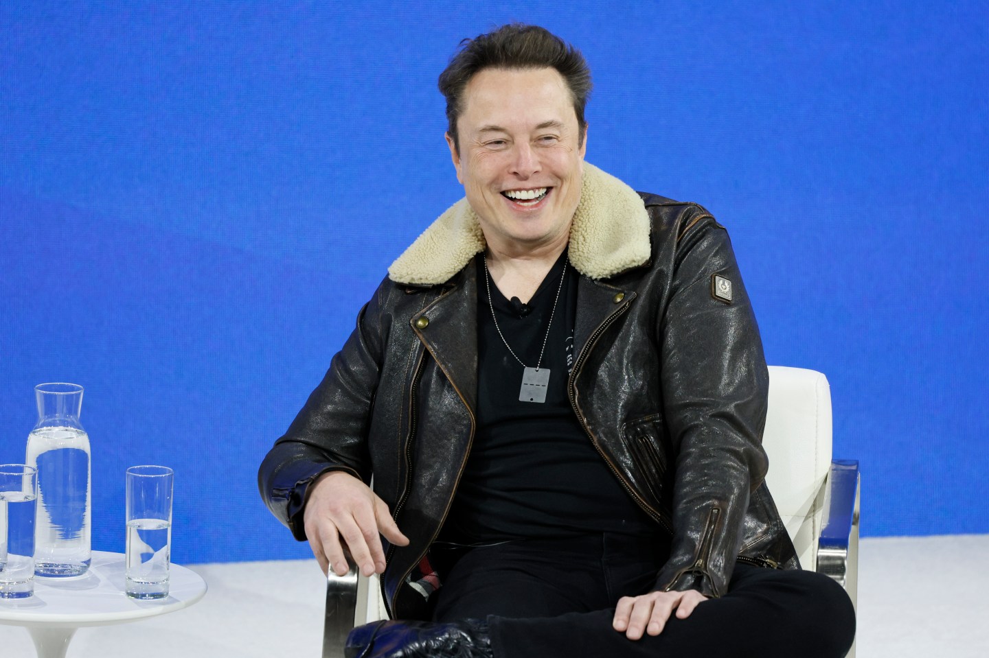 Elon Musk laughing on stage