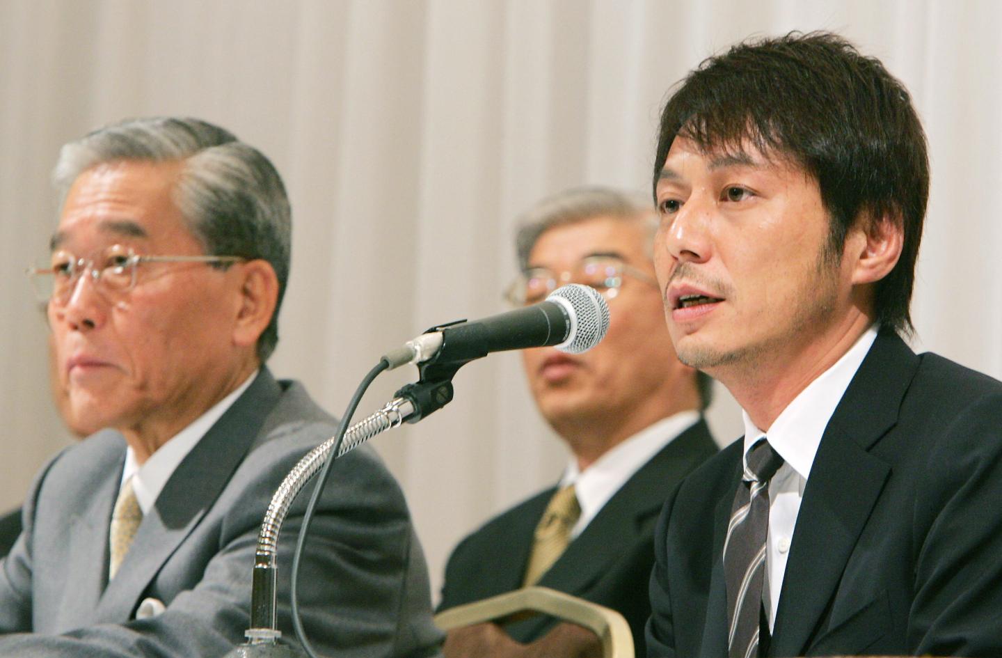 After years of refusing to be involved in the business, Yasuhide Uno only agreed to take it over when his dad was on his death bed — and he felt he had no choice. Here he is several years later, speaking (R) at a news conference in Tokyo, on March 16, 2006