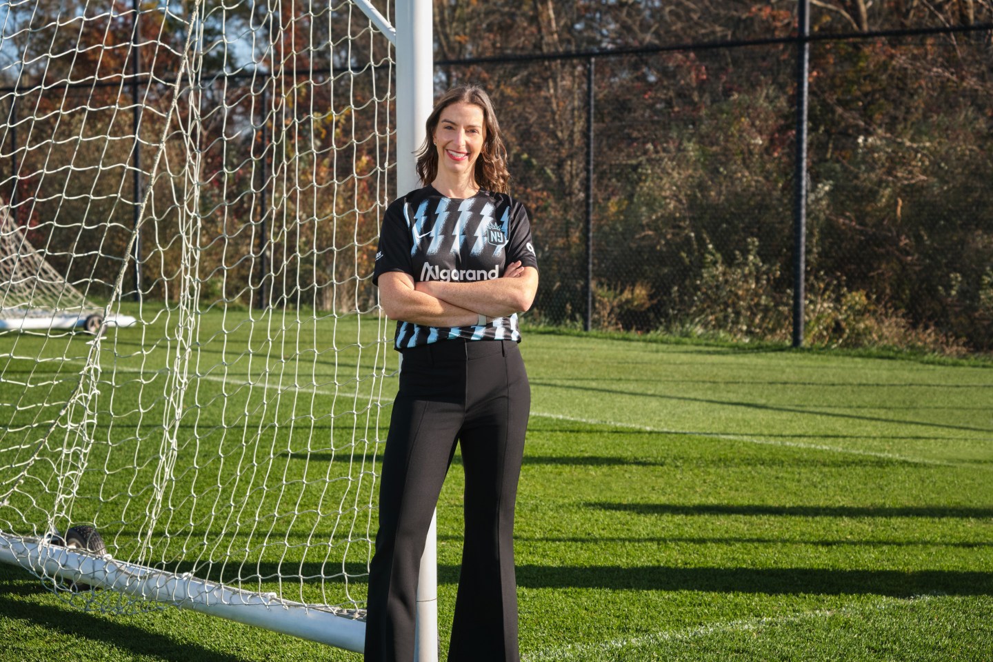 Carolyn Tisch Blodgett standing in front of a soccer goal