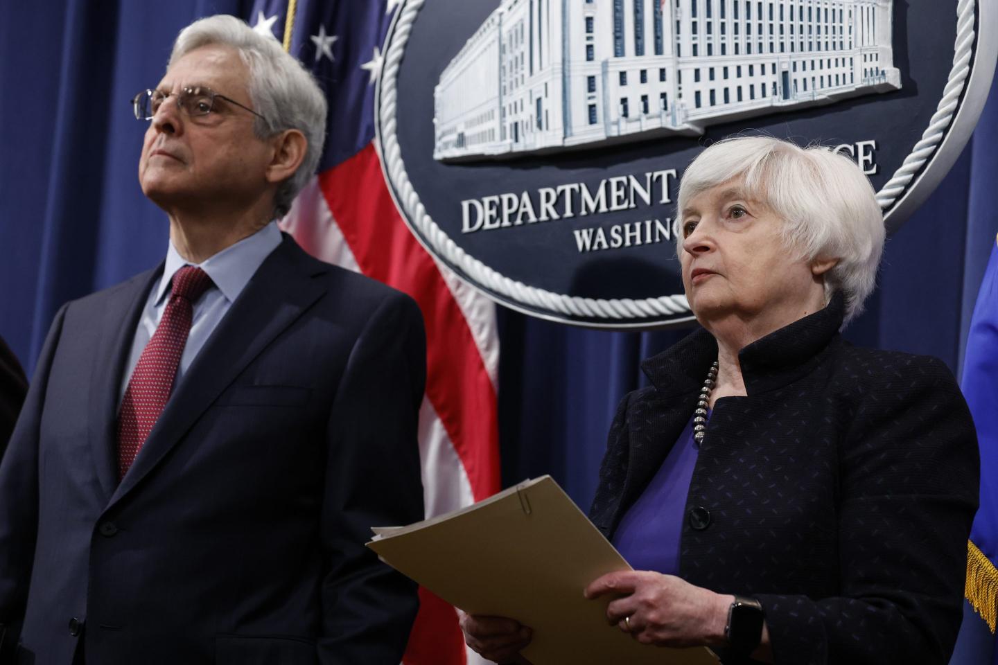 Attorney General Merrick Garland listens alongside Treasury Secretary Janet Yellen during a DOJ news conference on Nov. 21, 2023, in Washington.