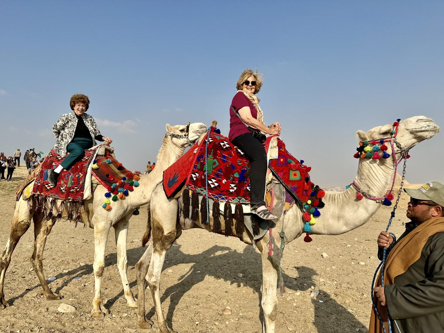 Photo of two women riding camels in Egypt