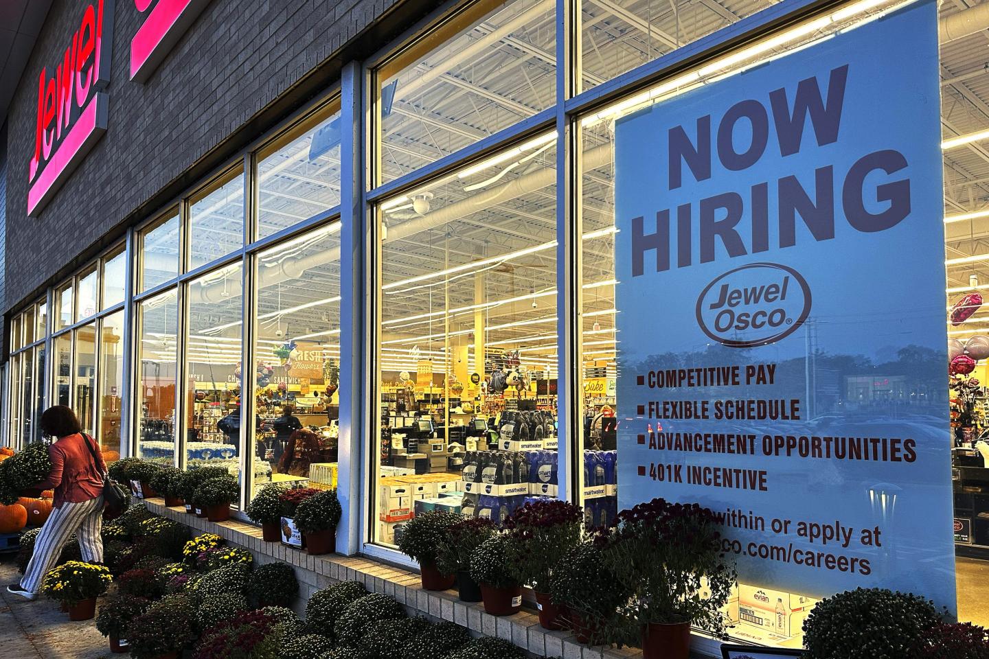 A hiring sign is displayed at a grocery store, on Oct. 5, 2023, in Deerfield, Ill.