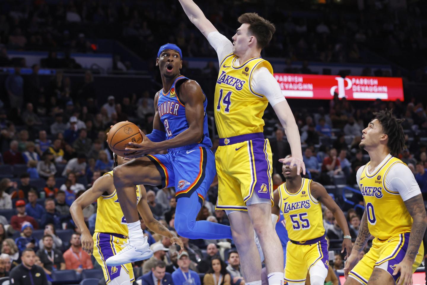 Oklahoma City Thunder guard Shai Gilgeous-Alexander (2) prepares to pass the ball away from Los Angeles Lakers center Colin Castleton (14) during the second half of an NBA basketball game Nov. 30, 2023, in Oklahoma City.