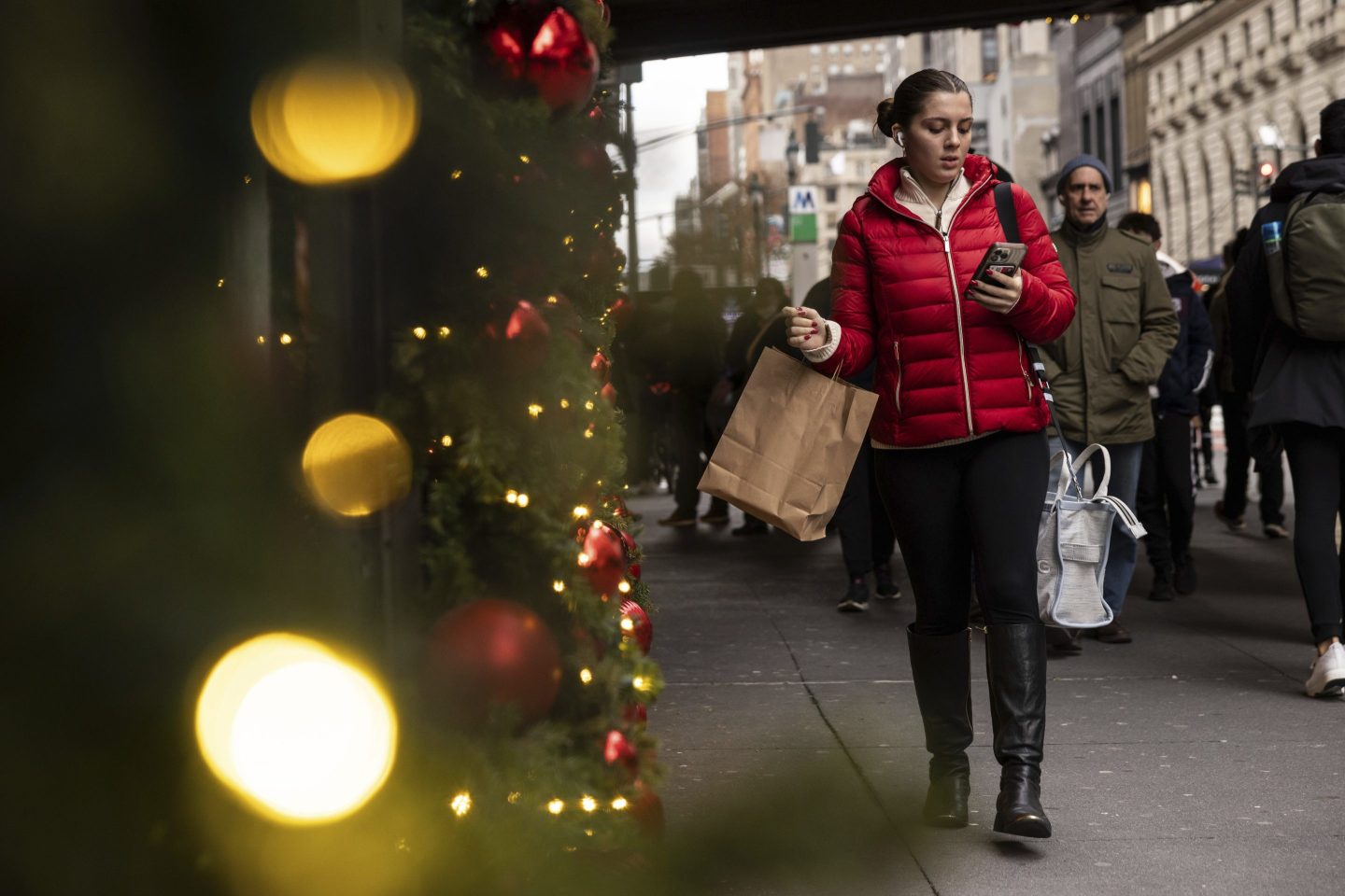 A woman carrying a shopping bag passes Macy's department store in Herald Square in New York City