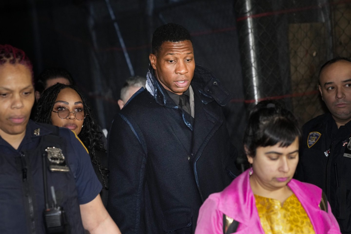 Jonathan Majors, third from left, leaves a courtroom in New York, on Dec. 18, 2023.