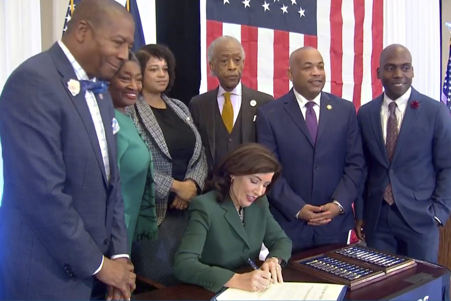 New York Gov. Kathy Hochul signs a bill in New York, on Dec. 19, 2023, to create a commission tasked with considering slavery reparations. She is joined by, from left: Dr. Yohuru Williams of the Racial Justice Initiative at the University of St. Thomas; Andrea Stewart-Cousins, Majority Leader of the NY State Senate; Michaelle Solages, NY State Assembly Woman; Rev. Al Sharpton; Carl Heastie, Speaker of the NY State Assembly; and James Sanders, NY State Senator.