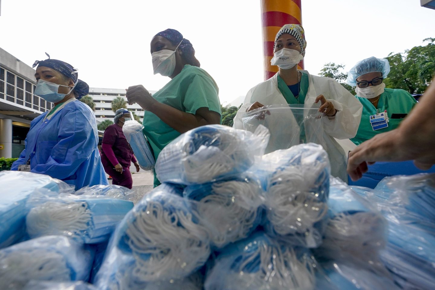 Healthcare workers line up for free personal protective equipment at Jackson Memorial Hospital, on Sept. 22, 2020, in Miami.
