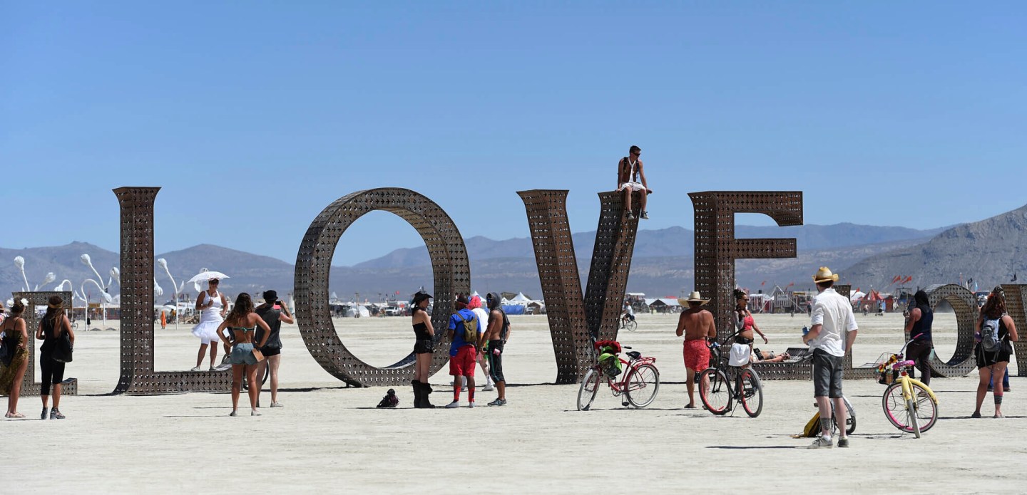 Participants walk around at the Burning Man festival on the Black Rock Desert of Gerlach, Nev., on Aug. 27, 2014.