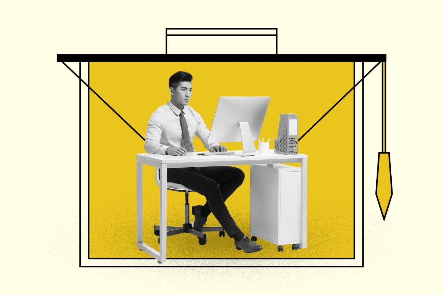 Man sitting with a shirt and tie working at a desk.