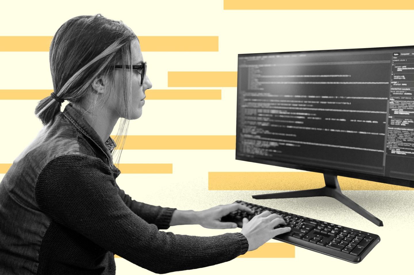 A woman sitting at a desk typing on a computer.