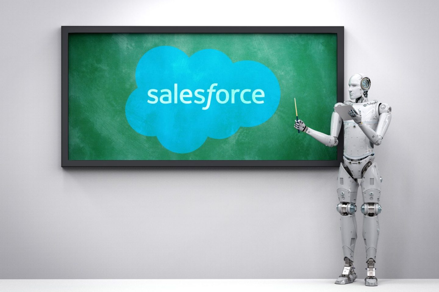 Photo of a robot holding a pointer in front of a chalkboard with the Salesforce logo on it.