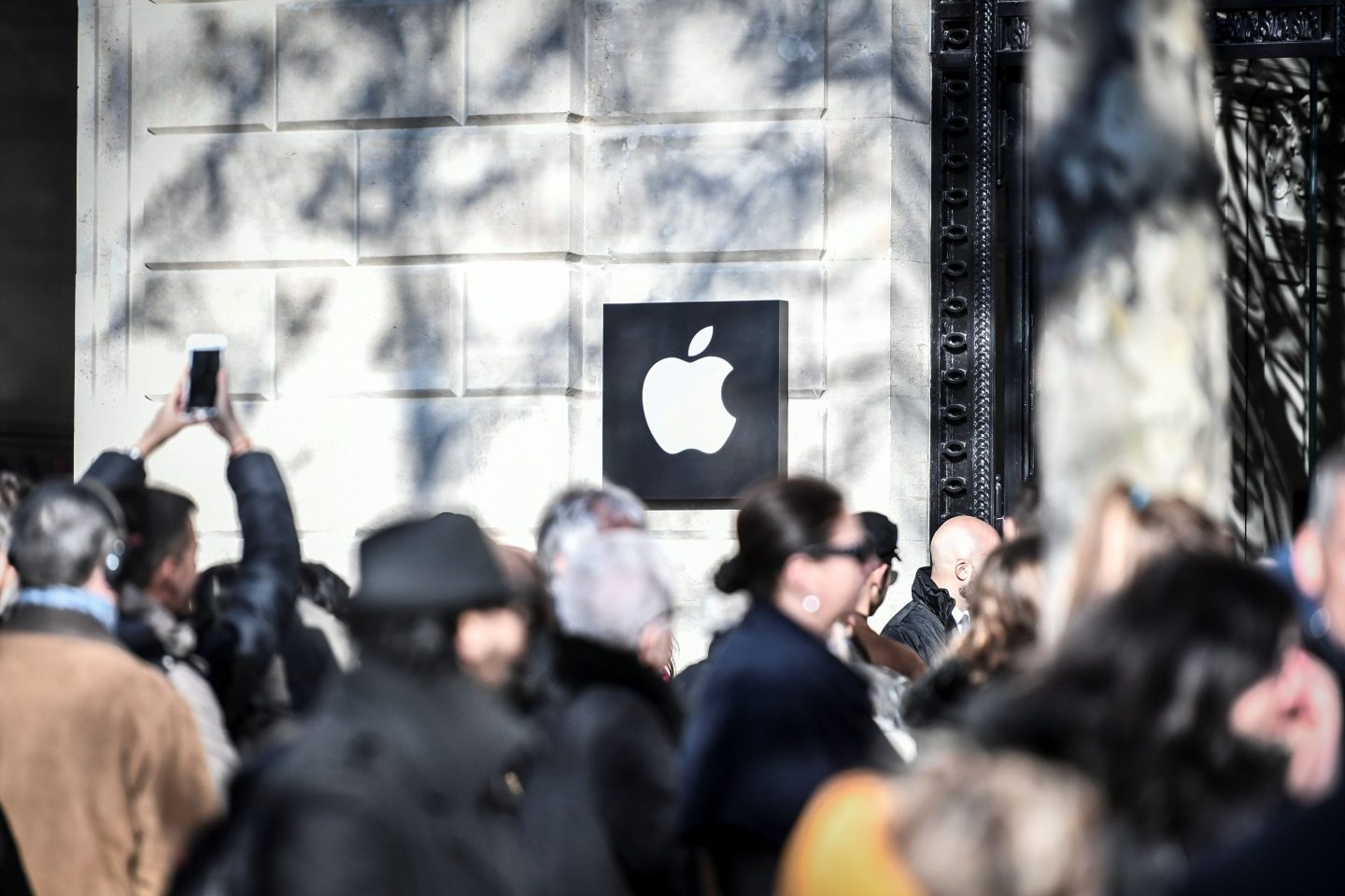 People queue outside the new Apple store on its opening day on the Champs Elysees Avenue in Paris, France.