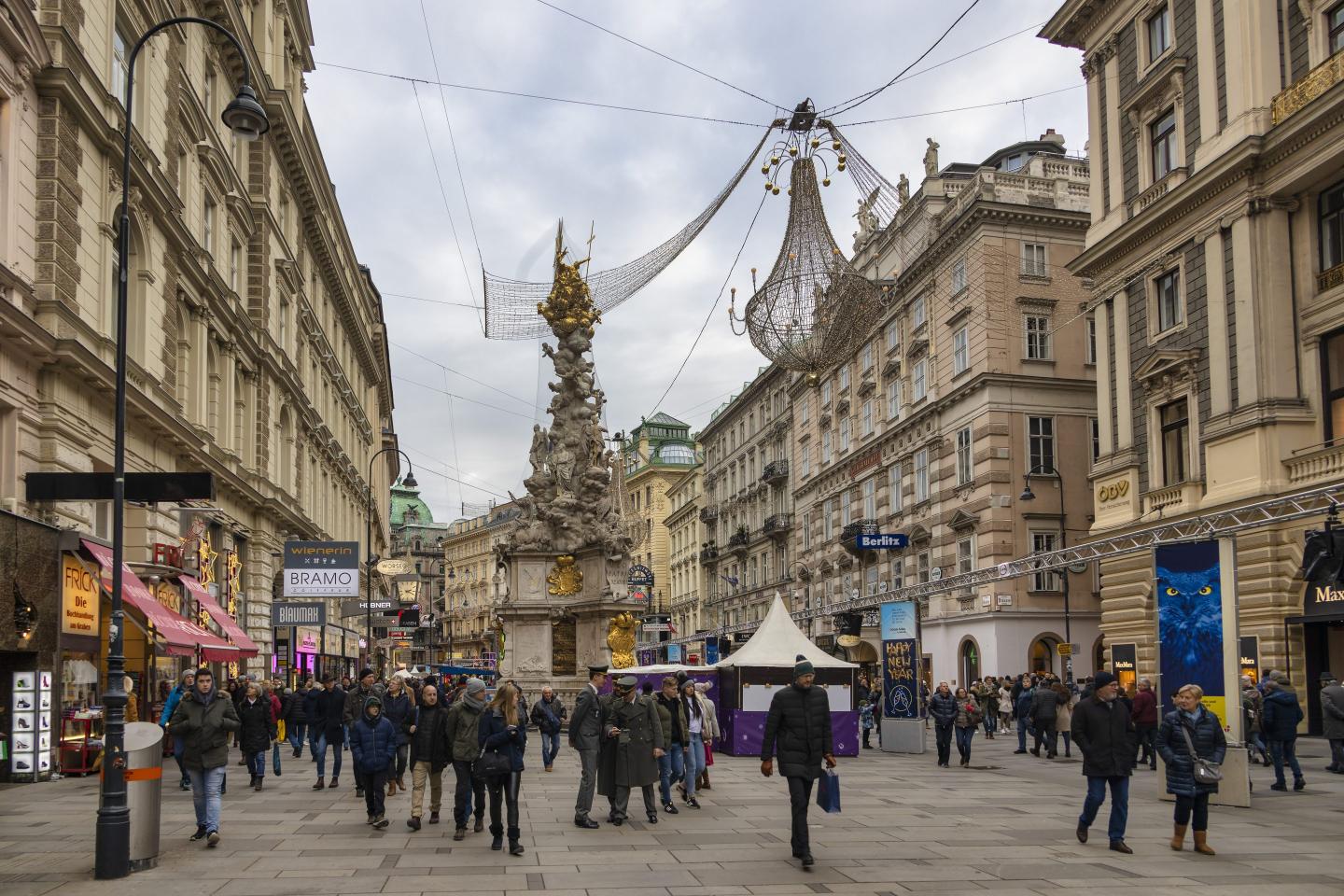 Tourists walk around the Plague Column at the Graben street in Vienna, Austria.