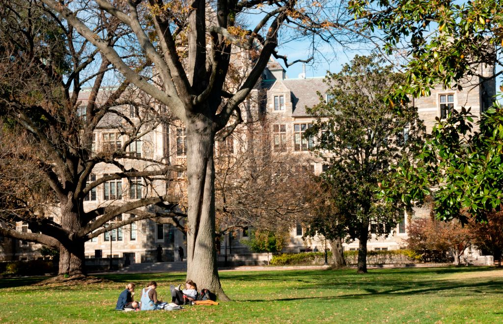 Students studying on the campus of Georgetown University, Washington, D.C., as seen in November 2019. (Photo by: Robert Knopes—Universal Images Group/Getty Images)