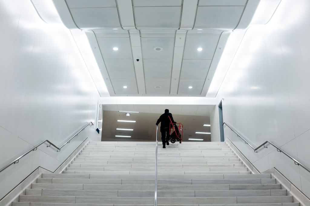 A commuter walks up a staircase at the Oculus transportation hub in New York, U.S., as seen in March 2020. (Photographer: Demetrius Freeman—Bloomberg/Getty Images)