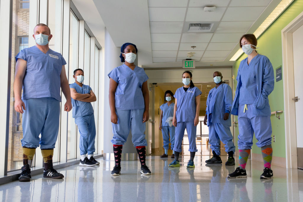 Health care workers in the acute care COVID unit at Harborview Medical Center, as seen in May 2020 in Seattle, Washington. (Photo by Karen Ducey/Getty Images)