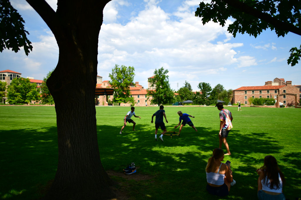A group of incoming freshmen play spike ball on campus after moving into dormitories at the University of Colorado Boulder, as seen in August 2020. (Photo by Mark Makela/Getty Images)