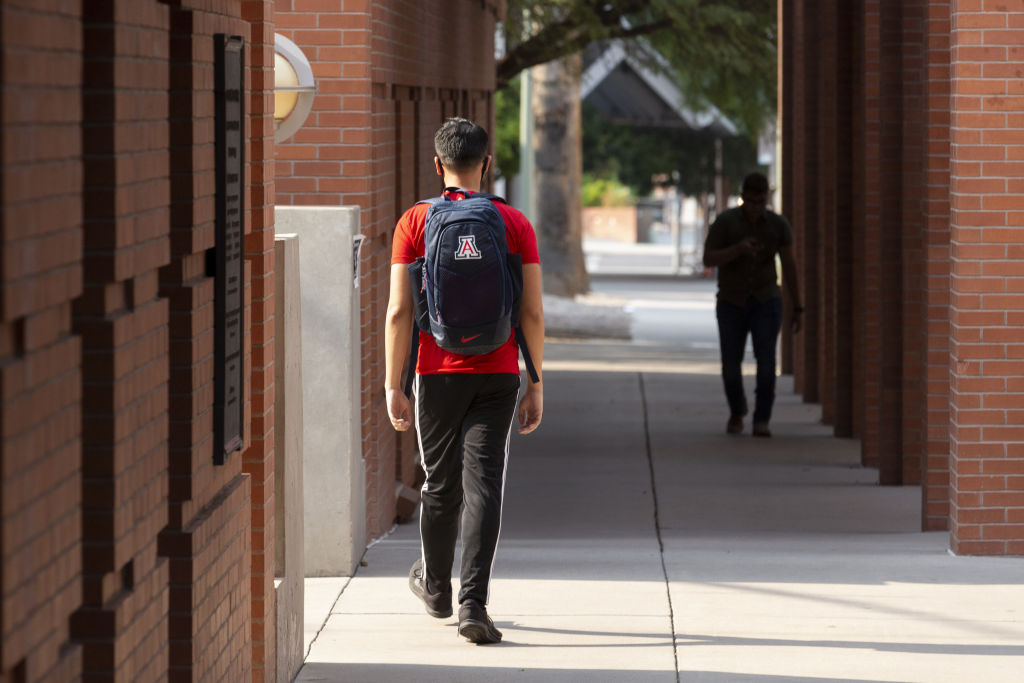 Students walk through the campus at the University of Arizona in Tucson, Arizona, as seen in August 2020. (Photographer: Cheney Orr—Bloomberg/Getty Images)