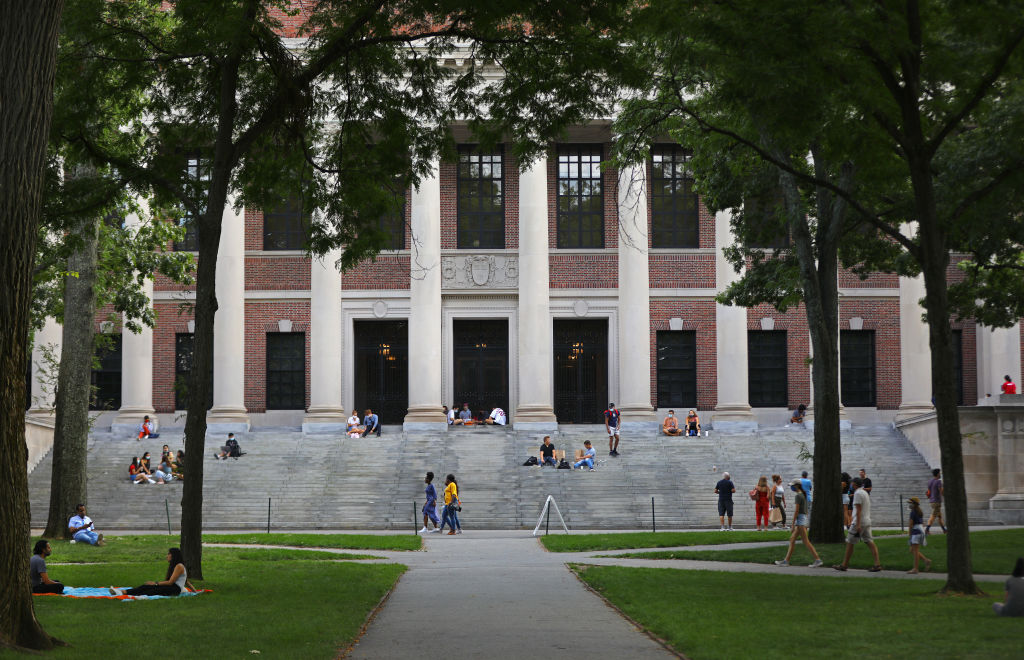Students and visitors mingle in Harvard Yard, as seen in September 2020. (Photo by Pat Greenhouse—The Boston Globe/Getty Images)
