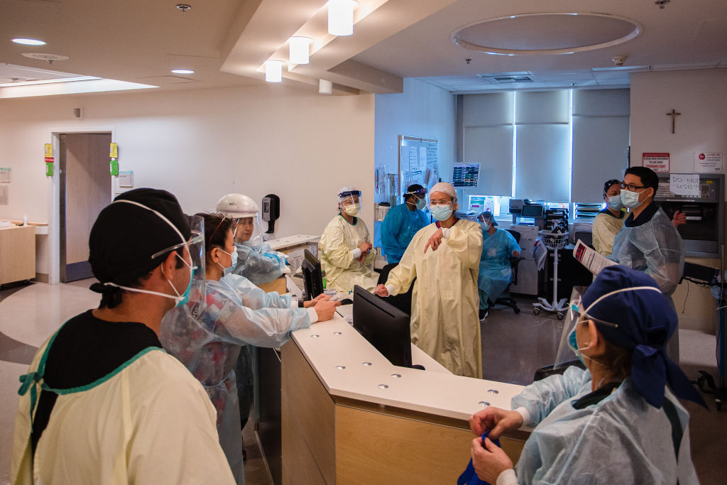 Registered nurses meet for a daily huddle at a nurse's station at Providence Holy Cross Medical Center in Mission Hills, California, as seen in February 2021. (Photographer: Ariana Drehsler—Bloomberg/Getty Images)