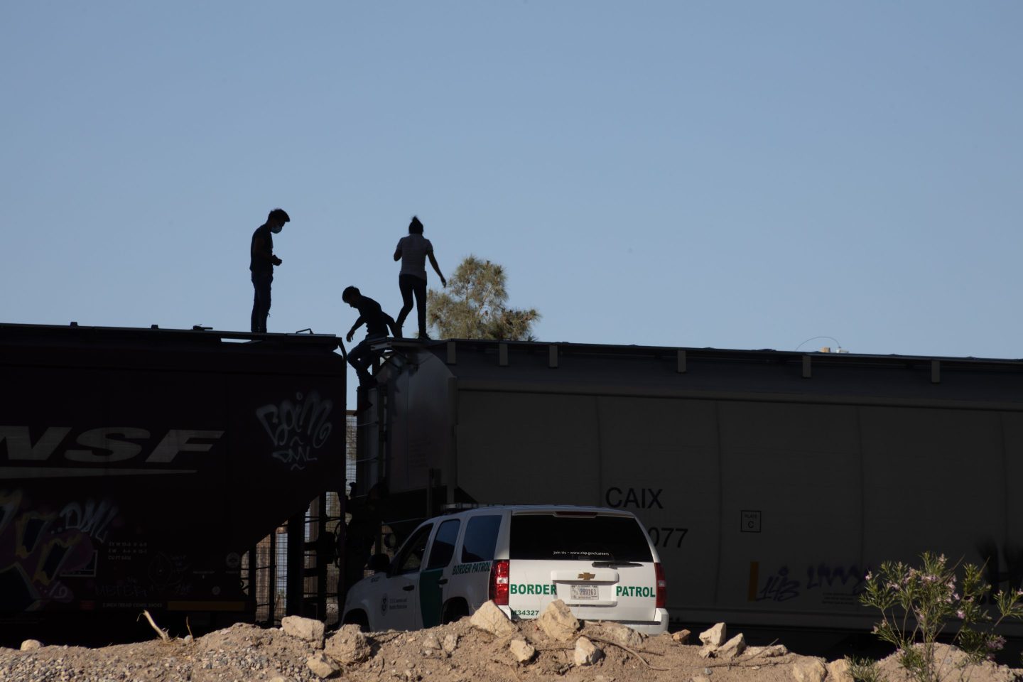 Three young migrants traveling on a freight train crossing the border in El Paso were discovered by the Border Patrol and asked to get off the train.