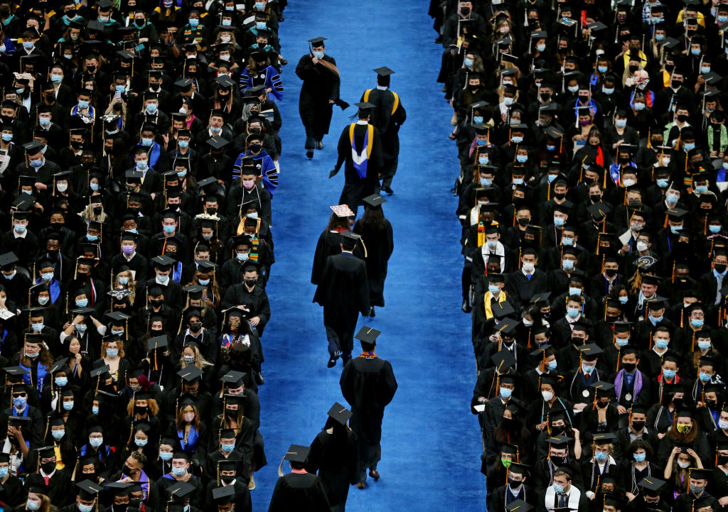 University of Massachusetts graduates file down the aisle during a commencement ceremony at Boston’s TD Garden in August 2021. (Photo by Craig F. Walker—The Boston Globe/Getty Images)
