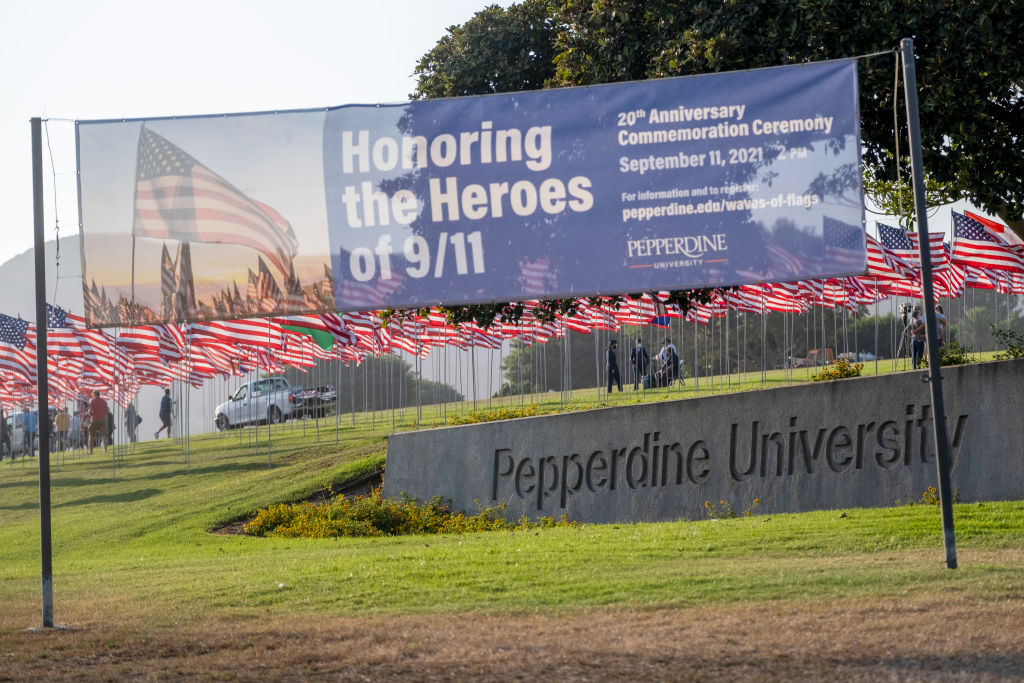 Volunteers place flags on the lawn in front of Pepperdine University for their annual Wave of Flags display in Malibu, California, as ween in September 2021. (Photo by Hans Gutknecht—MediaNews Group/Los Angeles Daily News/Getty Images)