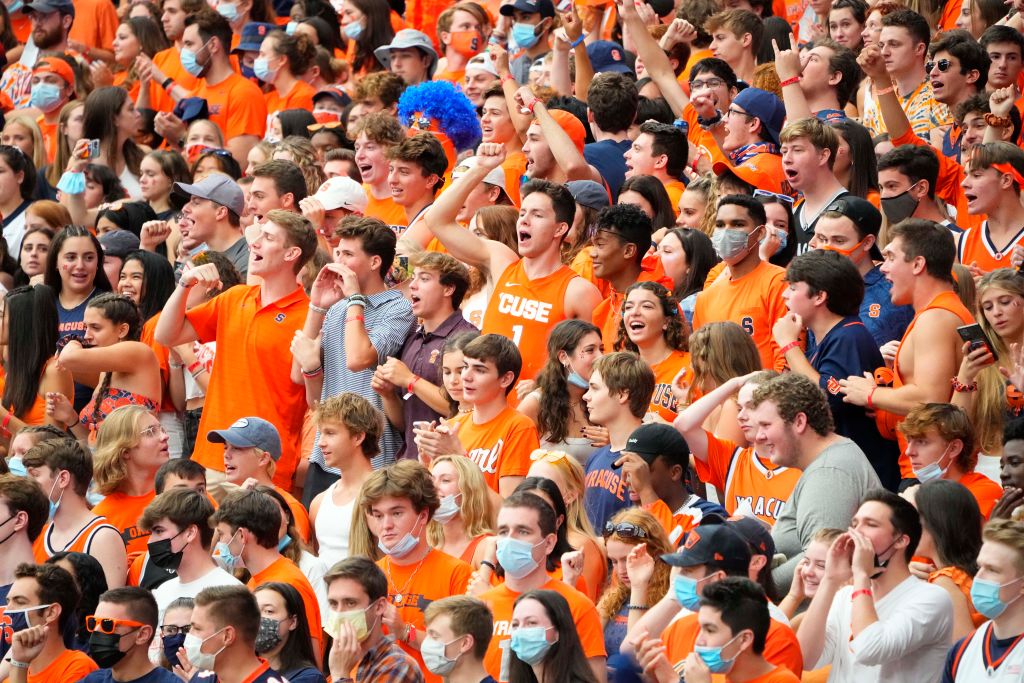 Students cheer during a football game in Syracuse, N.Y.