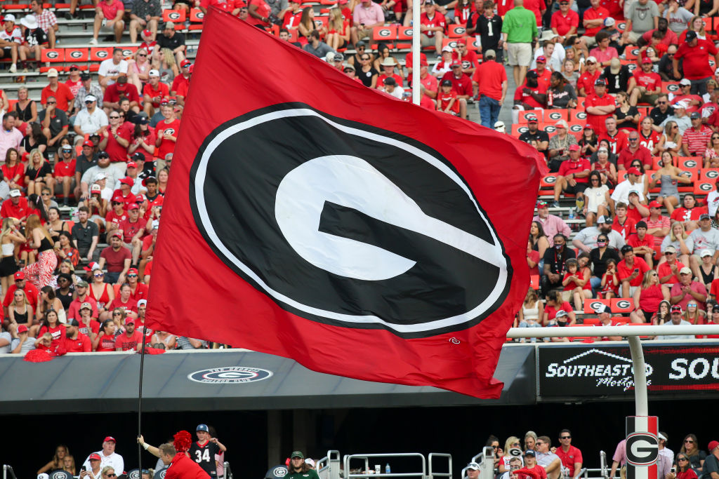 Cheerleaders run the Georgia Bulldogs flag after a score against the UAB Blazers in the second half at Sanford Stadium, as seen in September 2021 in Athens, Georgia. (Photo by Brett Davis/Getty Images)