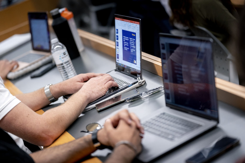 Students work on laptop computers during an MBA class at the George Washington University School of Business in Washington, D.C., as seen in September 2021. (Photographer: Stefani Reynolds—Bloomberg/Getty Images)