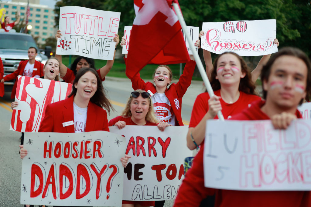 Indiana University student athletics board members march in the Indiana University Homecoming Parade, with banners and placards, as seen in October 2021. (Photo by Jeremy Hogan—SOPA Images/LightRocket/Getty Images)