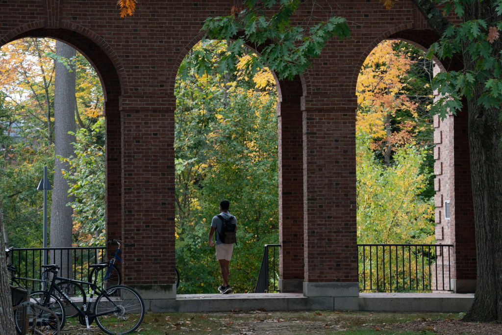 A student walks between dormitory buildings on the campus of Dartmouth College in Hanover, N.H., as seen in October 2021. (Photographer: Bing Guan—Bloomberg/Getty Images)