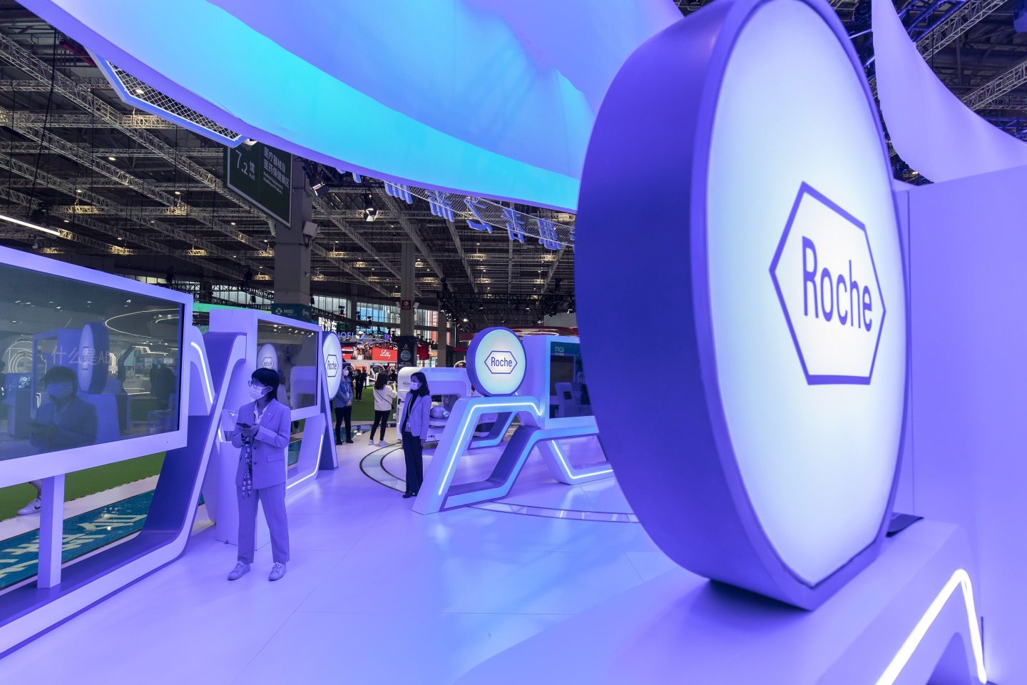 Visitors in a Roche Holding booth at the China International Import Expo (CIIE) in Shanghai, China, on Nov. 8, 2021.