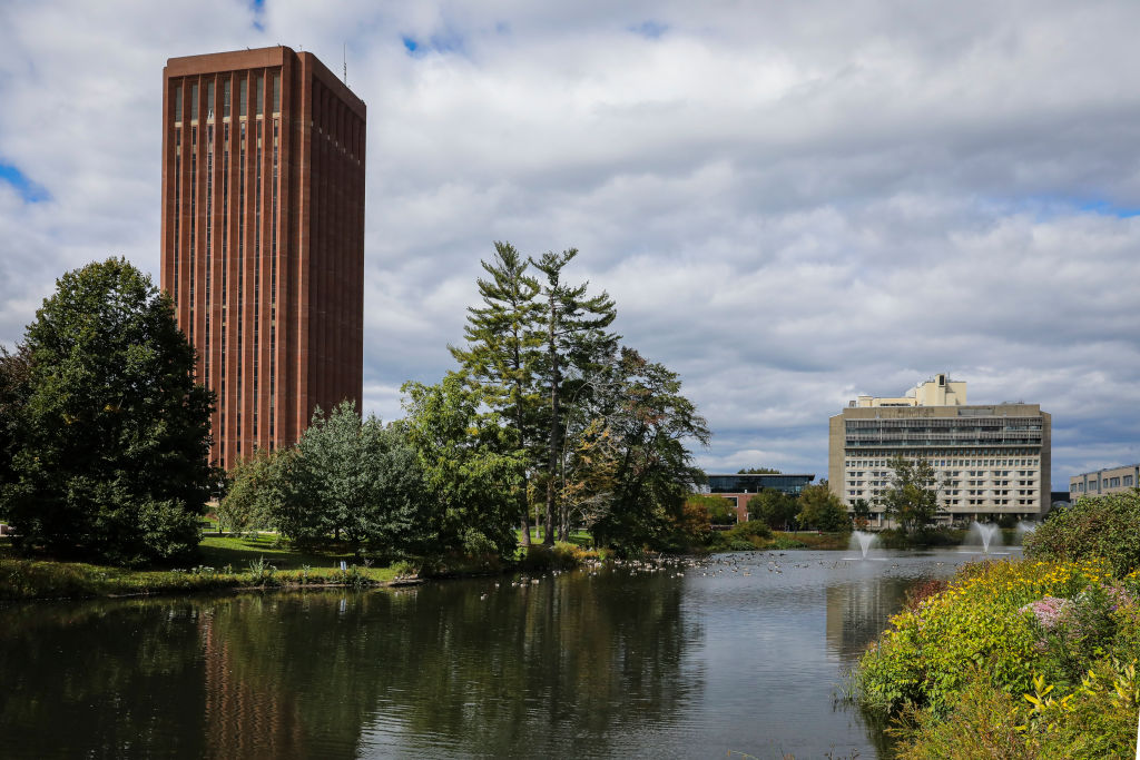 The W. E. B. Du Bois Library and the Integrative Learning Center are seen across the Campus Pond at UMass Amherst in Amherst, Massachusetts, as seen in September 2021. (Photo by Erin Clark—The Boston Globe/Getty Images)
