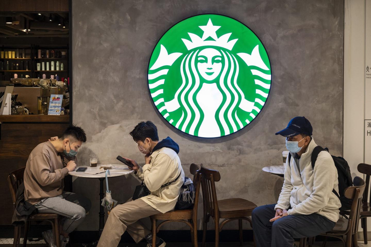 Customers are seen at the American multinational chain Starbucks Coffee store seen in Hong Kong.