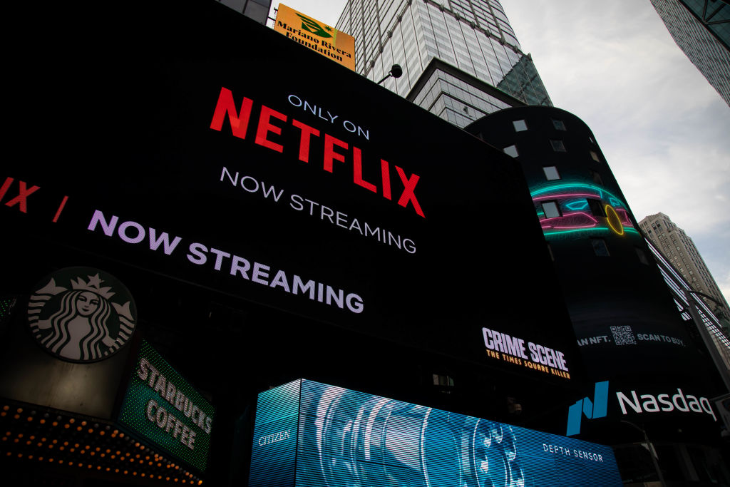 Netflix signage next to the Nasdaq MarketSite in New York, as seen in January 2022. (Photographer: Michael Nagle—Bloomberg/Getty Images)