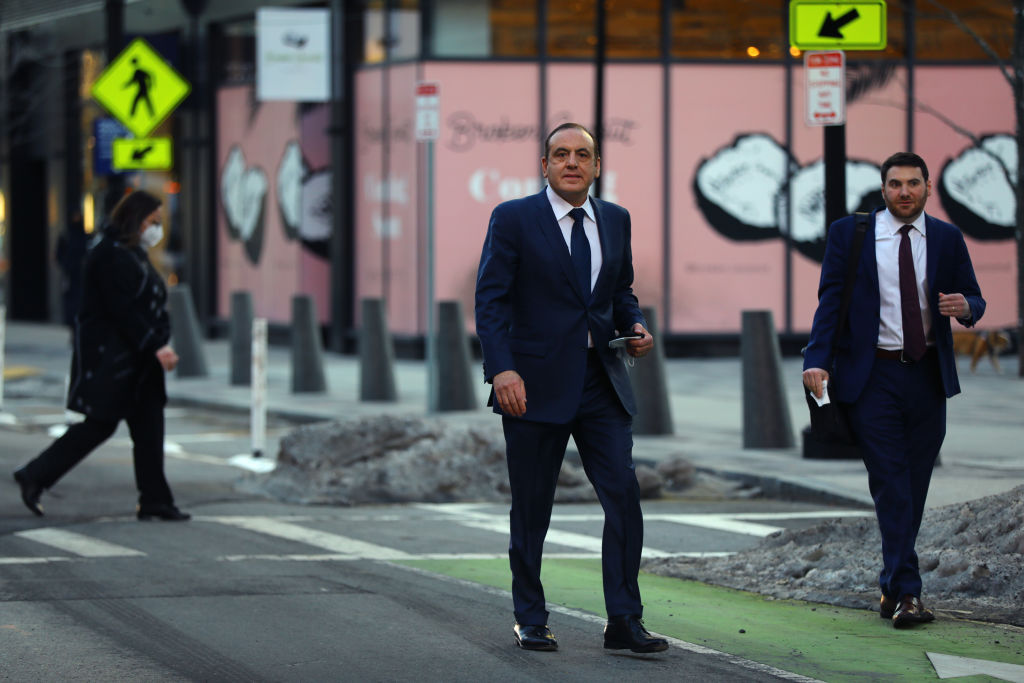 Gamal Abdelaziz, center, walks out of federal court, in South Boston, after being sentenced in the Varsity Blues case in Boston, as seen in February 2022. (Photo by Pat Greenhouse—The Boston Globe/Getty Images)
