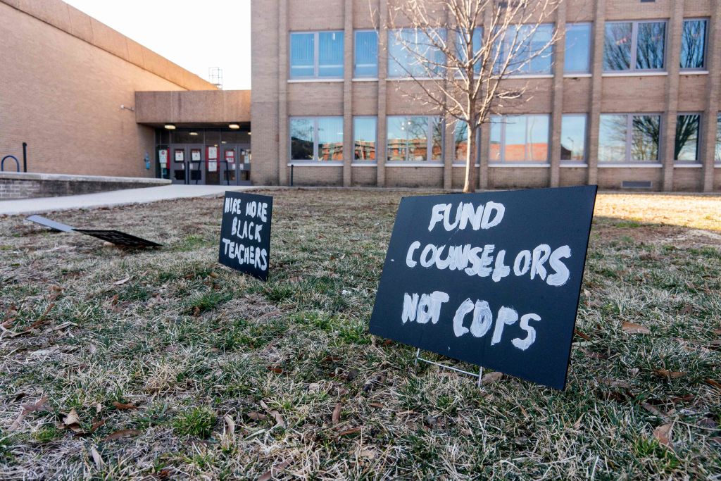 A sign reading Fund Counselors, Not Cops is displayed in front of an elementary school in Washington, DC, as seen in February 2022. (Photo by Stefani Reynolds—AFP/Getty Images)
