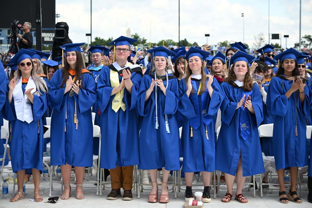 University of Delaware graduates applaud during the graduation ceremony at Delaware Stadium in Newark, Delaware, as seen in May 2022. (Photo by MANDEL NGAN—AFP/Getty Images)