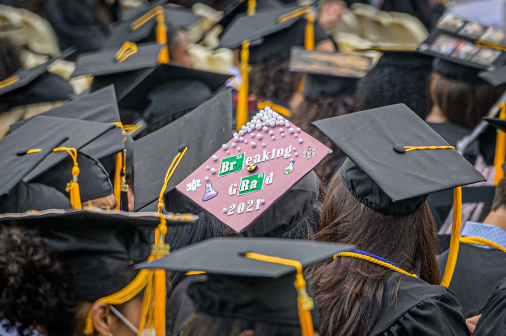 A City College of New York graduate student seen wearing a decorated cap, as seen in June 2022. (Photo by Erik McGregor—LightRocket/Getty Images)