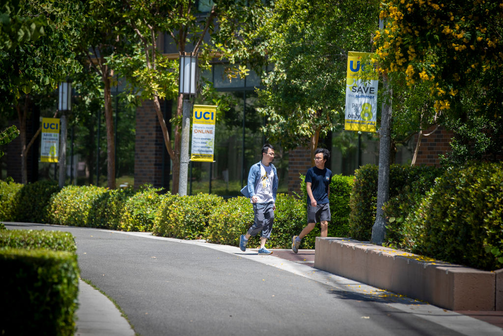 Pedestrians walk through campus at the University of California-Irvine, as seen in June 2022. (Photo by Allen J. Schaben—Los Angeles Times/Getty Images)