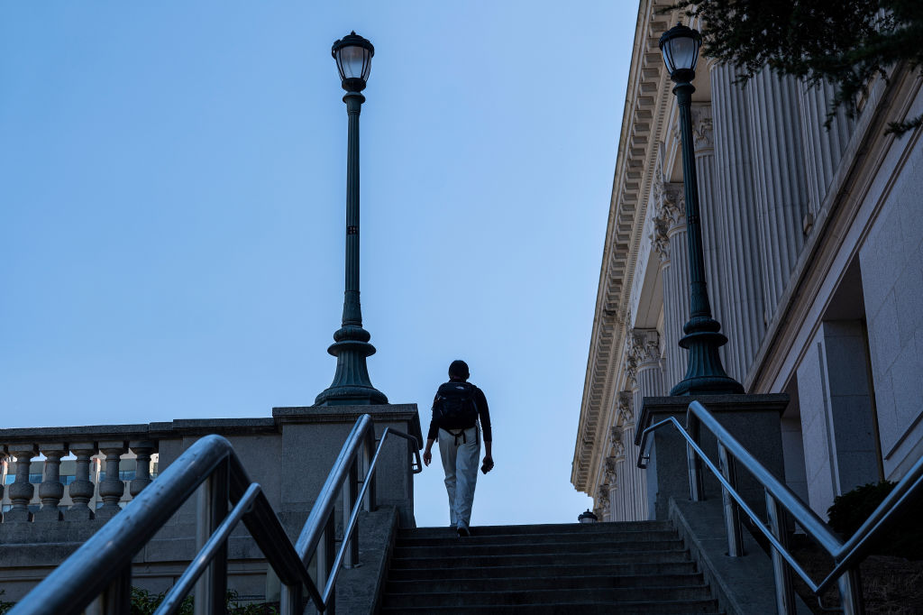 A student walks up steps on the University of California at Berkeley campus as seen in August 2022. (Photographer: David Paul Morris—Bloomberg/Getty Images)