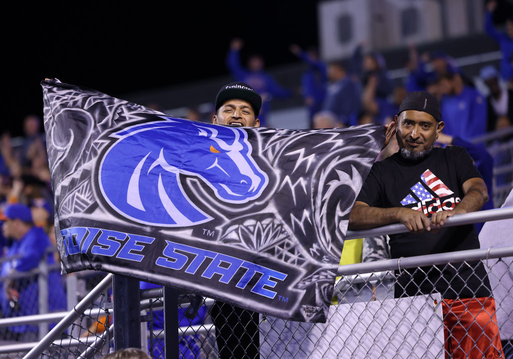 Boise State Broncos fans pose for the camera during a regular season NCAA football game, as seen in September 2022 in Boise, Idaho. (Photo by Marc Sanchez—Icon Sportswire/Getty Images)