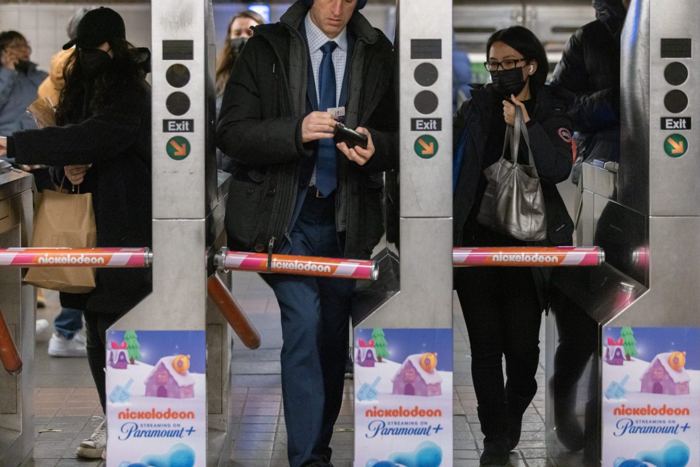 Commuters enter a subway station in New York, as seen in December 2022. (Photographer: Jeenah Moon—Bloomberg/Getty Images)