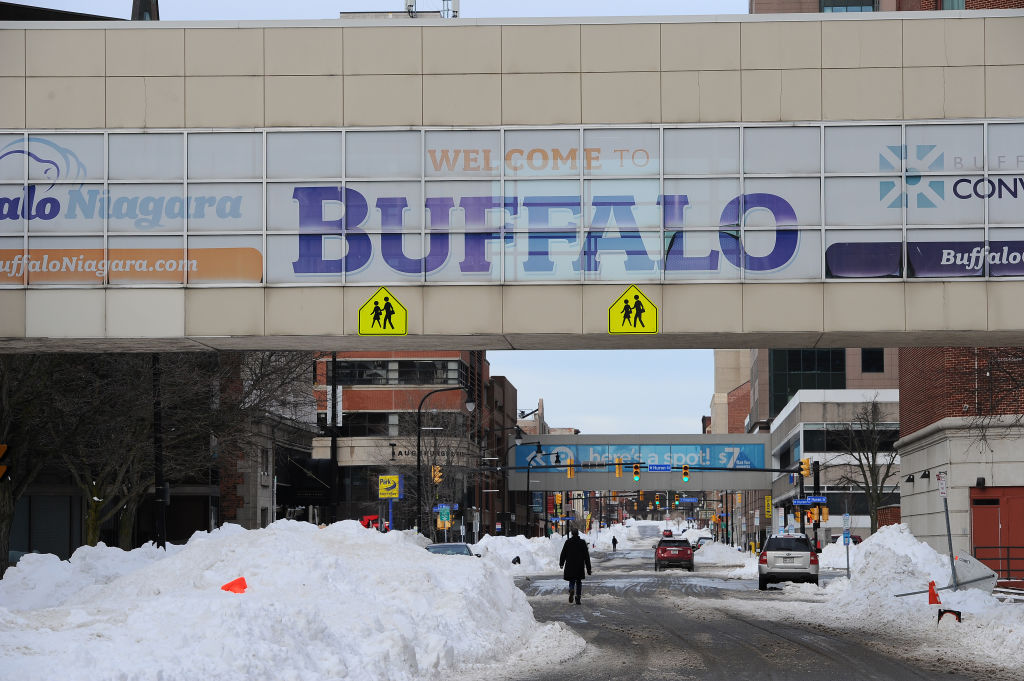 Pedestrians walk along Ellicott Street in downtown Buffalo, as seen in December 2022 in Buffalo, New York. (Photo by John Normile/Getty Images)