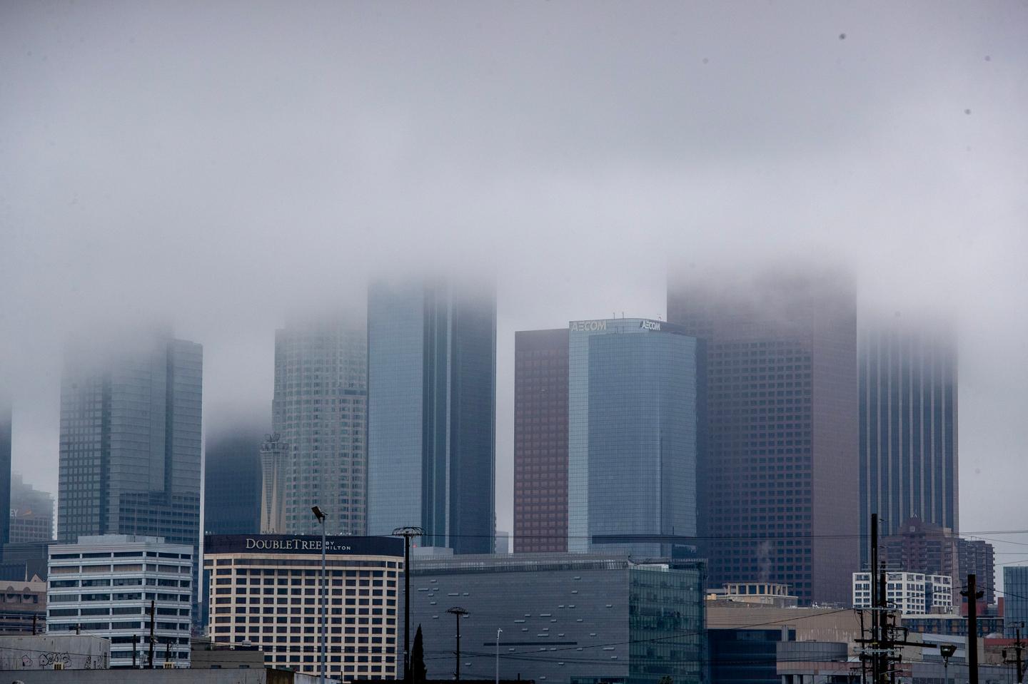 Low clouds obscure the tops of downtown skyscrapers in Los Angeles