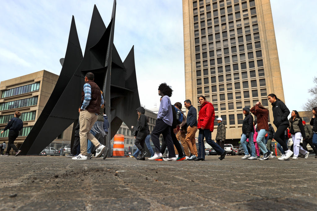 A group passes the Alexander Calder sculpture "The Big Sail" while touring the MIT campus, as seen in April 2023. (Photo by David L. Ryan—The Boston Globe/Getty Images)