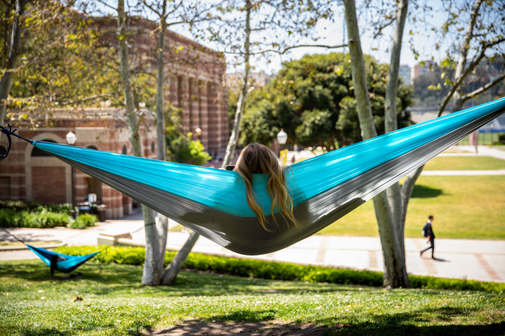 University of California, Los Angeles students take an afternoon hammock break during warm weather on a sunny afternoon in Los Angeles, as seen in April 2023. (Photo by Jay L. Clendenin—Los Angeles Times/Getty Images)