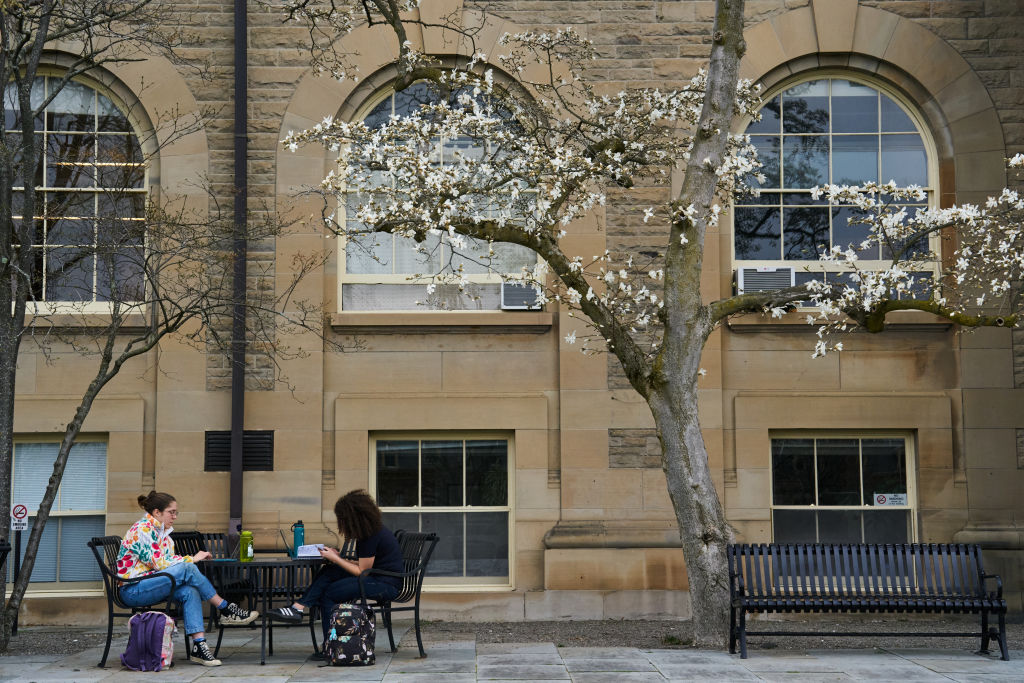Students outside Goldwin Smith Hall at the Cornell University campus in Ithaca, New York, as seen in April 2023. (Photo by: Bing Guan—Bloomberg/Getty Images)