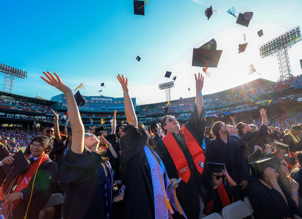 Northeastern University students celebrate the conclusion of their University's 121st undergraduate commencement at Fenway Park, as seen in May 2023. (Photo by Matthew J. Lee—The Boston Globe/Getty Images)